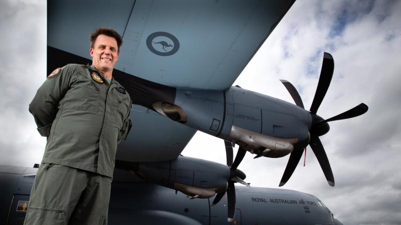 Squadron Leader Michael Phillips with a No. 37 Squadron C-130J Hercules on the flightline at RAAF Base Richmond. Photo: Corporal David Said