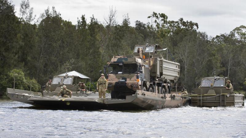  Students from the Bridge Erection Propulsion Boat course manoeuvre a bridge transporting a HX77 truck on the Georges River, Sydney. Photo: Petty Officer Lee-Anne Cooper
