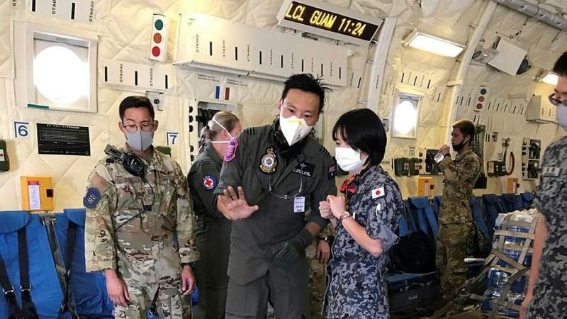 Medical Officer Flight Lieutenant Doctor Perlon Leung, centre, with Japan Air Self-Defense Force and United States Air Force colleagues in a JASDF C-2 during Exercise Cope North. Photo: Squadron Leader Emma Flack 