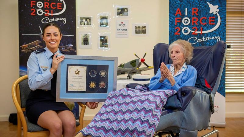 Leading Aircraftwoman Emma Singleton with the Chief of Air Force award presented to her great-grandmother Betty Howells to mark her 100th birthday. Photo: Sergeant Bill Solomou