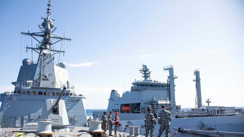 HMAS Hobart ship's company maintains the distance line during a replenishment-at-sea approach with Royal New Zealand Navy tanker HMNZS Aotearoa. Photo: Leading Seaman Ryan Tascas