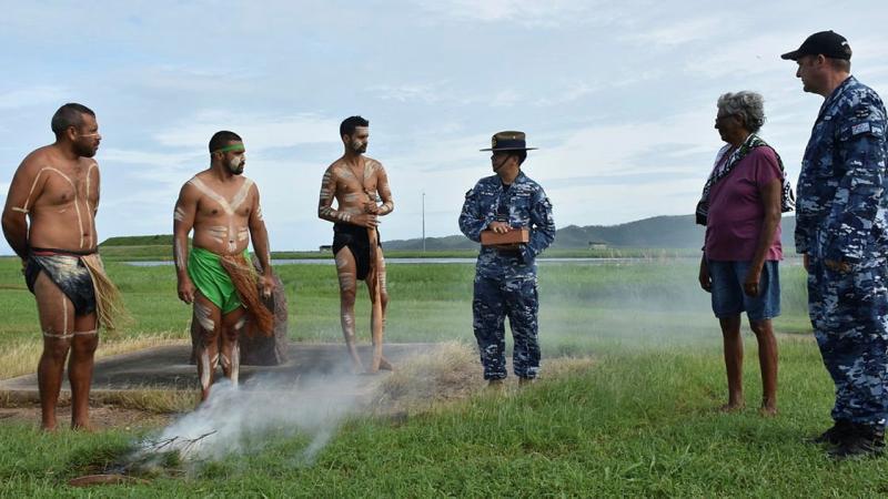 Les Tanna, left, Ashley Saltner, Glen Thomas, Flight Lieutenant David Williams holding soil from Wulgurukaba land, Virginia Wyles and Wing Commander Mathew Green at RAAF Base Townsville. Photo: Corporal Luke Garner