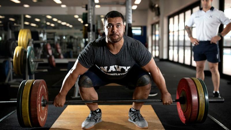 Weightlifter Leading Seaman Suamili Nanai trains at HMAS Stirling in Western Australia under the watchful eye of Leading Seaman Physical Training Instructor Jakob Pekolj. Photo: Petty Officer Yuri Ramsey