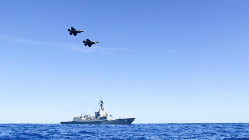 A pair of Air Force F35-A Lightning aircraft conduct a flypast over HMAS Hobart during Exercise Tasman Shield. Photo: Petty Office BT Matchett