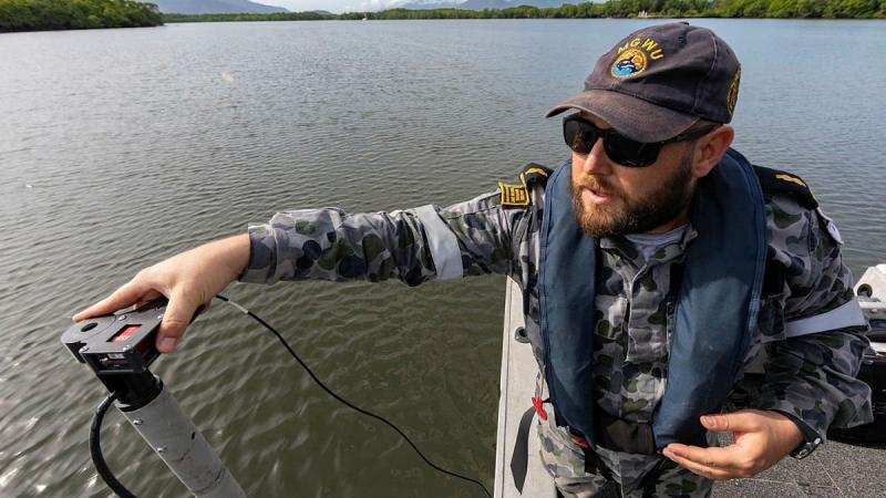 Able Seaman Hydrographic Systems Operator Andrew Hespe prepares to do a hydrographic survey in Chinaman Creek, Cairns. Photo: Leading Seaman Shane Cameron