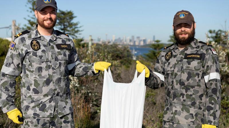 Sub-Lieutenants Nicholas Croke, left, and William Anderson from HMAS Watson participate in the Clean-Up Australia Day event in Sydney. Photo: Able Seaman Benjamin Ricketts