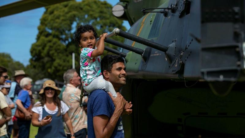 Local residents take a tour of Navy MRH-90 Taipan during HMAS Choules visit to ceremonial homeport of Mallacoota. Photo: Leading Seaman Leo Baumgartner  