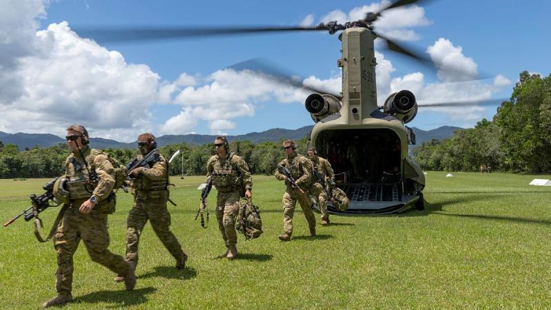 Soldiers from the 3rd Battalion exit a CH-47 Chinook during air mobile and stability operations training at the Combat Training Centre - Jungle Training Wing, Tully, Queensland. Photo: Corporal Brandon Grey