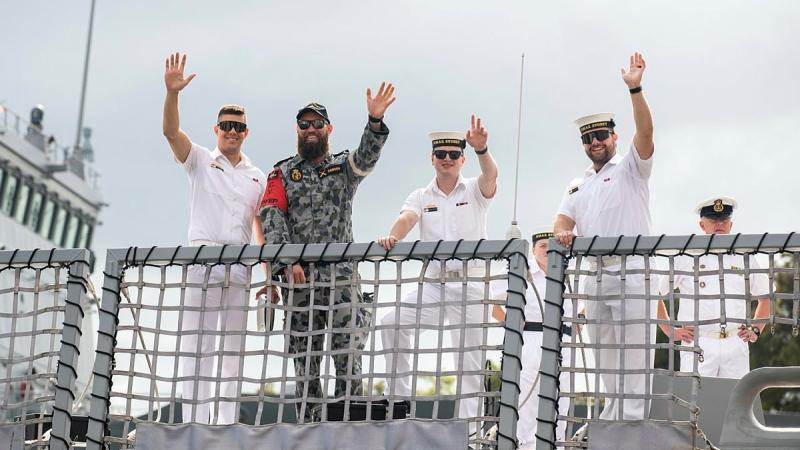 From left, Leading Seaman Luke Healy, Leading Seaman Calum Dawson, Leading Seaman Neale Fruend and Leading Seaman Jakeb Morrison wave as HMAS Sydney prepares to depart Garden Island. Photo: Leading Seaman Tara Morrison