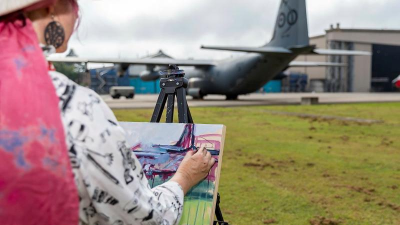 Mellissa Read-Devine, of the Ferry Artists Gallery, paints a RAAF C-130J on canvas with acrylic during the RAAF Base Richmond Artists’ Day. Photo: Corporal Dan Pinhorn