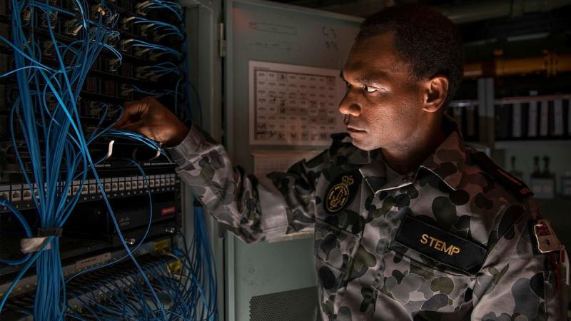 Able Seaman Communications and Information Systems Duncan Stemp conducts maintenance on HMAS Anzac’s Local Area Network. Photo: Leading Seaman Thomas Sawtell
