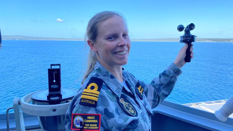Meteorologist and oceanographer Lieutenant Commander Fiona Simmonds uses an anemometer to measure wind speed aboard HMAS Canberra in Jervis Bay.
