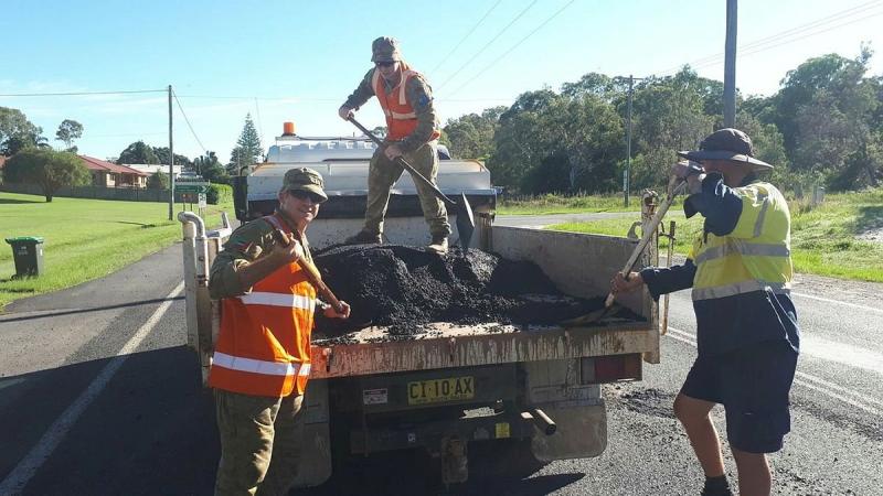 Members of 41st Royal New South Wales Regiment assist with repairs to roads damaged by flooding on the NSW mid-north coast.