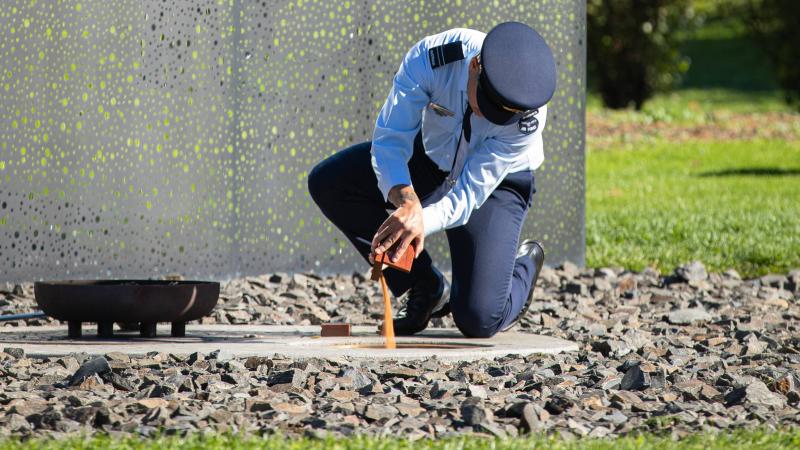 Flight Lieutenant Steven Warrior places a sample of country at the Australian War Memorial, Canberra. Photo: Leading Aircraftman Adam Abela