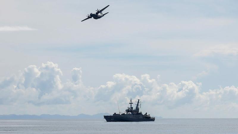 A Royal Australian Air Force C-27J Spartan flies over HMAS Maitland off the coast of Honiara, Solomon Islands, during a maritime surveillance patrol for illegal fishing activity on Operation Solania. Photo: FLTLT Peter Spearman
