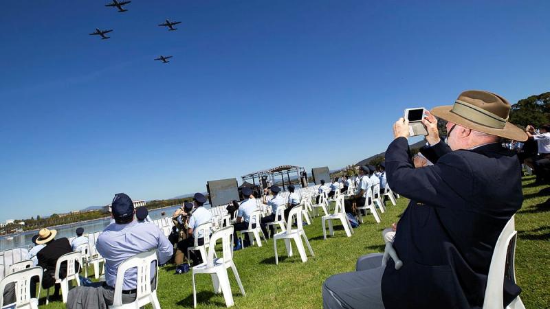 Air Force veteran Alan Sullivan takes photos of aircraft from his vantage point at Rond Terrace, Canberra, during the Air Force centenary flyover. Photo: Corporal David Said