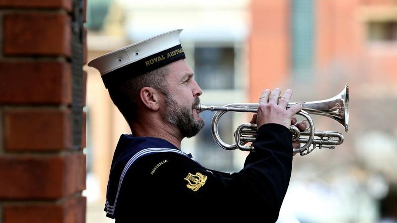 Leading Seaman Musician Marcus Salone plays the Last Post during a memorial service held on completion of the Freedom of Entry at the Bathurst War Memorial. Photo: Able Seaman