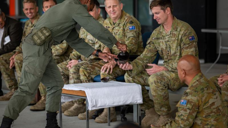 Private Sireli Levukaiciwa from the Republic of Fiji Military Forces gives Kava to the Commanding Officer of 8th/9th Battalion, the Royal Australian Regiment, Lieutenant Colonel John Eccleston. Photo: Private Jacob Hilton 