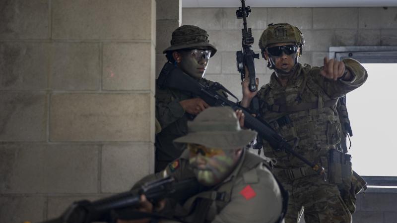Corporal James Milne from the 8th/9th Battalion, Royal Australian Regiment, right, with Republic of Fiji Military Forces’ Private Seruwaia Kovakova, front, and Lance Corporal Apimeleki Nabati during urban training. Photo: Corporal Nicole Dorrett