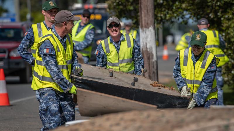 Air Force personnel remove flood-damaged items from local homes and streets in Port Macquarie during Operation NSW Flood Assist. Photo: Private Jacob Hilton