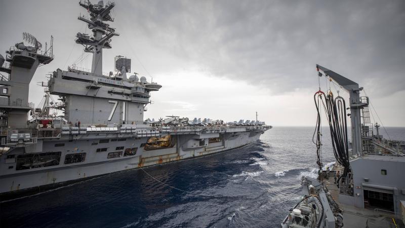 HMAS Sirius conducts a replenishment at sea with USS Theodore Roosevelt. Photo: Leading Seaman Thomas Sawtell
