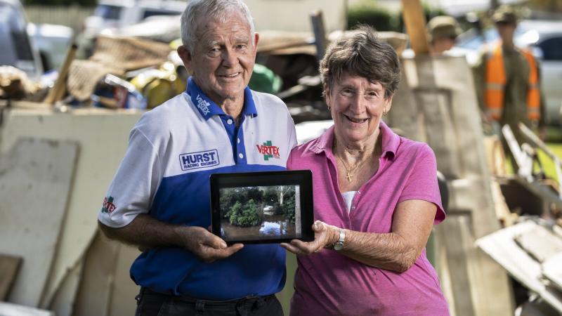 Alan and Janice Hunt stand in front of flood damaged possessions in Lower MacDonald, NSW. Photo: Corporal Sagi Biderman 
