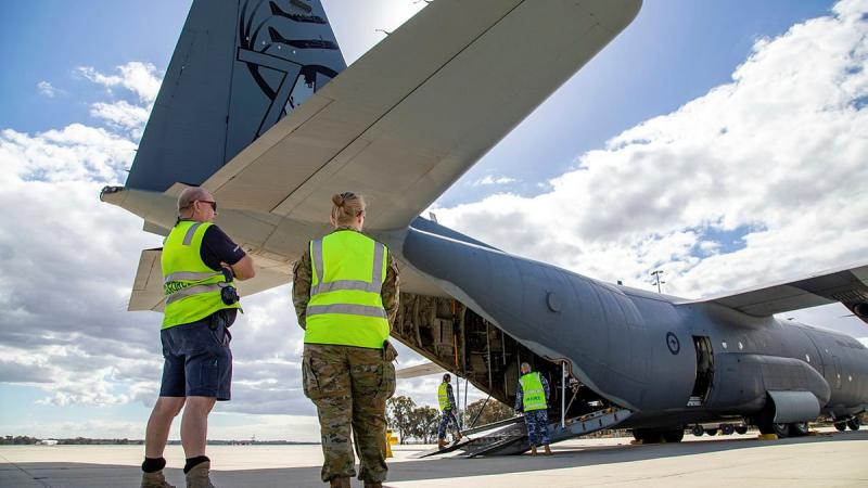 Sergeant John Braken (left) and Corporal Amber Nichols observe the loading of a C-130J Hercules at RAAF Base Pearce as part of Defence's support to the WA Government following Tropical Cyclone. Photo: Petty Officer Yuri Ramsey