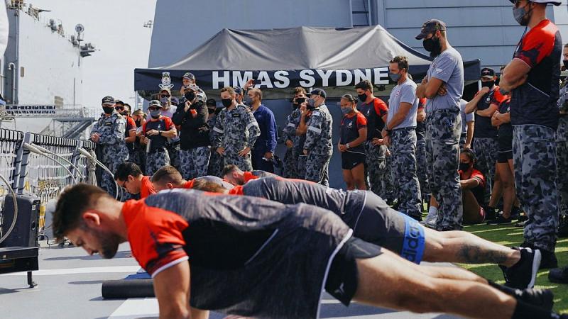 Male crew members from HMAS Sydney compete in a push-up challenge against the US Navy at Pier 4 in San Diego, US.