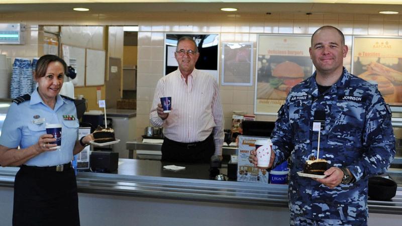 Veteran Paul Beraldo with Squadron Leaders Robyn Connell and Dane Johnson inside the Army and Air Force Canteen Service at RAAF Laverton.