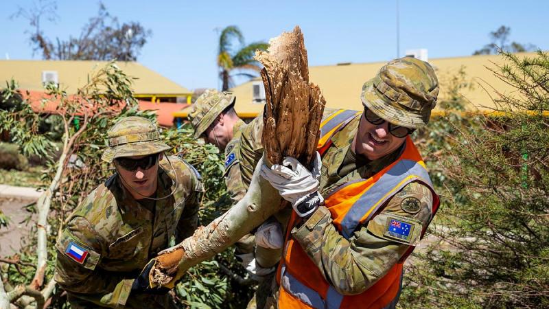  Privates Jordan Stidworthy, left, and Jarryd Kirby remove fallen branches and debris from Northampton District High School after Tropical Cyclone Seroja. Photo: Leading Seaman Kieren Whiteley 
