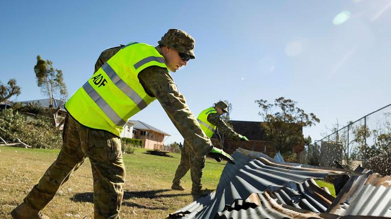 Private Troy Zinetti, left, and Lance Corporal Will Gillespie-Harp remove debris from St Mary's Primary School, Northampton, following Tropical Cyclone Seroja. Photo: Leading Seaman Kieren Whiteley