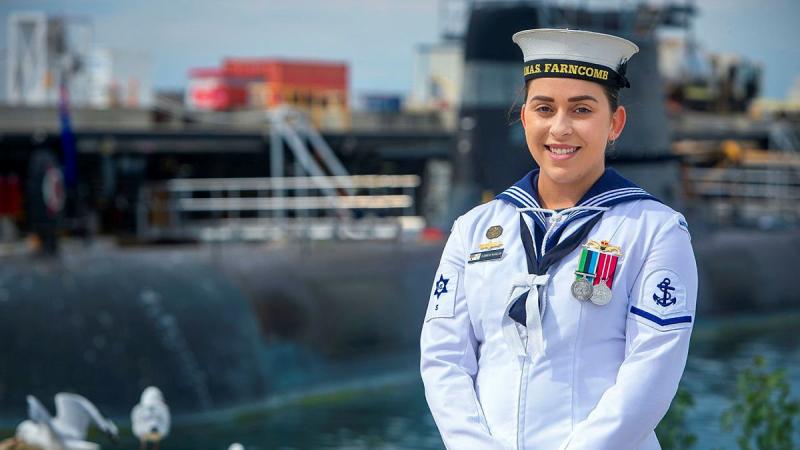 Leading Seaman Elizabeth McCallum in front of HMAS Collins at Fleet Base West in Rockingham, WA. Photo: Leading Seaman Richard Cordell 