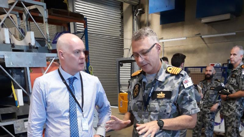 Director of Mission Systems PTY David Battle discusses with Captain Etienne Mulder from the Mine Warfare and Clearance Diving Group about the use of a generator used to jam mine firing systems.