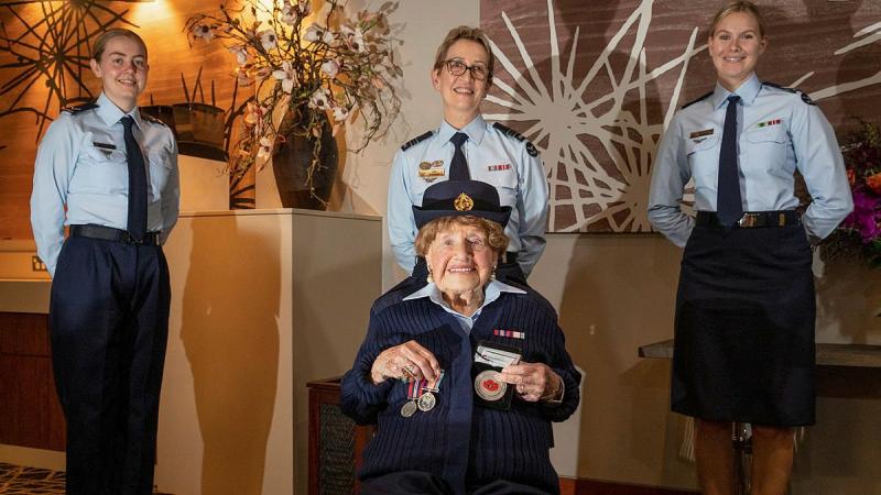 Leading Aircraftwoman Carley Dunn, left, Squadron Leader Del Gaudry, and Corporal Maddison Henson stand with Mrs Iris Terry during a formal presentation of a uniform at the Fairfield RSL. Photo: Corporal Kylie Gibson