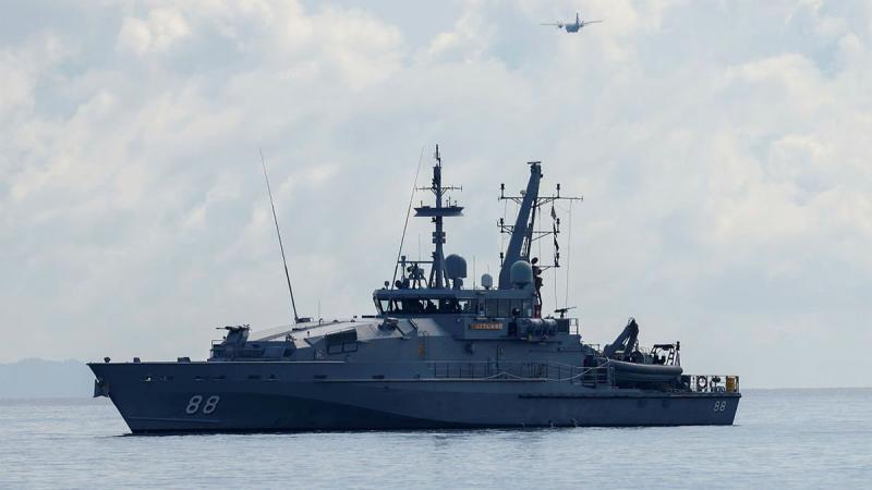 HMAS Maitland off the coast of Honiara, Solomon Islands, and an Air Force C27-J Spartan during a maritime surveillance patrol for illegal fishing activity on Operation Solania. Photo: Flight Lieutenant Peter Spearman
