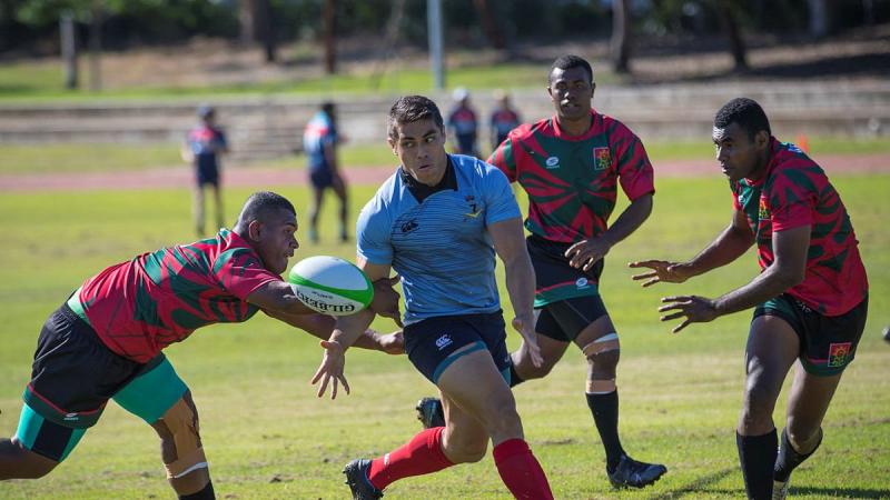 A player from the Republic of Fiji Military Forces team, left, attempts to intercept Craftsman Shaun Coel during the Malo-Bula Cup at Gallipoli Barracks. Photo: Private Hamid Farahani