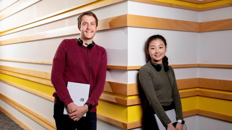 Service operators Weijin Min and Ben Larsen at Services Australia Flood Assist relief call centre. Photo: Jay Cronan