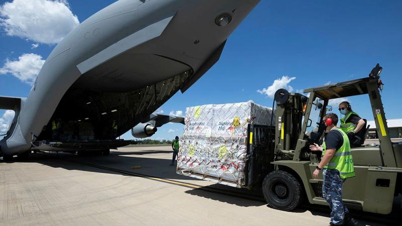 Air movements operators from No. 13 Squadron load pallets of humanitarian aid bound for Timor Leste onto a C-17A Globemaster III A41-212 at RAAF Base Darwin. Photo: Petty Officer Peter Thompson 