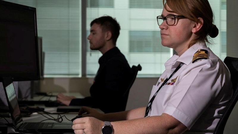 Lieutenant Commander Katherine Garrett works alongside Commonwealth Department of Health staff at the Vaccination Operations Centre in Canberra. Photo: Corporal Julia Whitwell