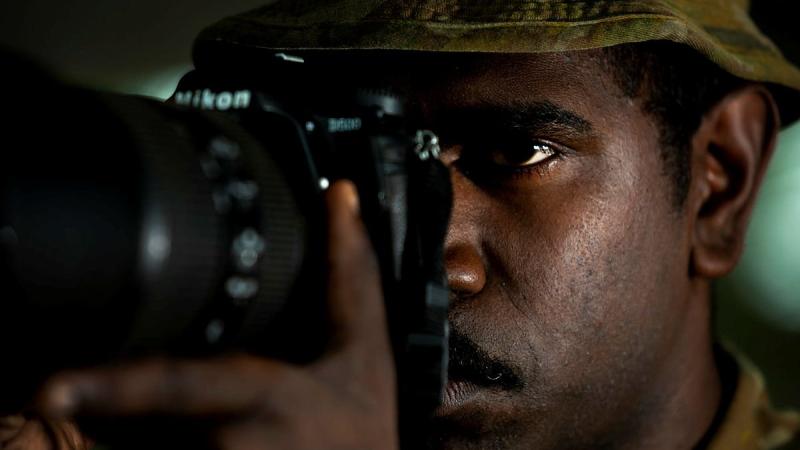 Private Daniel Charlie takes a photo of a watercraft approaching Boigu Island. Photo: Sergeant Sebastian Beurich