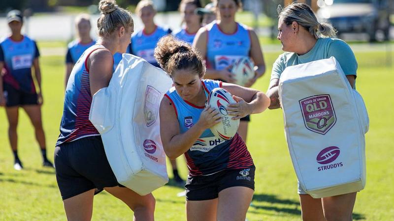 Private Kiara Hawkins from the Australian Defence Force Woman's Rugby League team charges the hit pads during a training session at Leslie Patrick Park in Arana Hills, Brisbane. Photo: Leading Seaman Steve Thomson