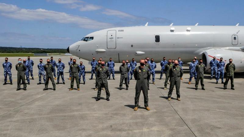 No. 11 Squadron personnel in front of an Air Force P-8A Poseidon aircraft at Kadena Air Base in Okinawa, Japan during Operation Argos.