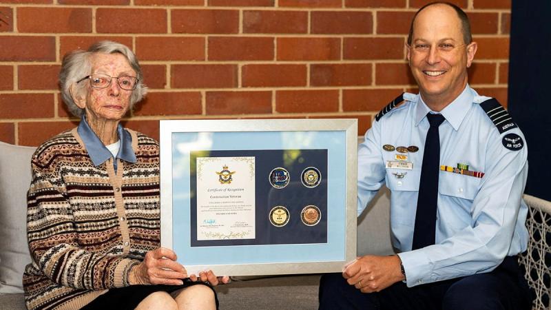 Women’s Auxiliary Australian Air Force veteran Beryl Barton is presented an Air Force 2021 commemorative memento by Senior Australian Defence Force Officer RAAF Base Wagga Group Captain Chris Ellison. Photo: Sergeant John Marshall
