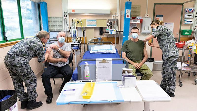 Defence Secretary Greg Moriarty and Chief of the Defence Force General Angus Campbell receive their first dose of the AstraZeneca COVID-19 vaccine at the Duntroon Health Centre, Canberra. Photo: Jay Cronan