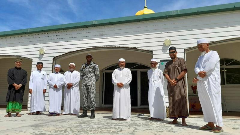 Able Seaman Ebrahim Dollie with members of the Cocos Keeling Islands mosque. Photo: Lance Corporal Casey Flanagan