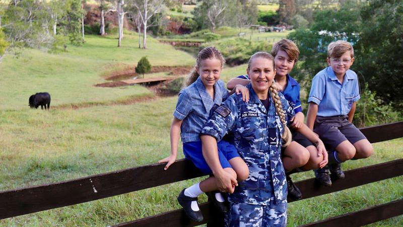 Leading Aircraftwoman Svitlana Pogrebnyak with her three children Christopher, centre, and twins Sophie and Matthew on their family property near RAAF Base Amberley in Queensland.