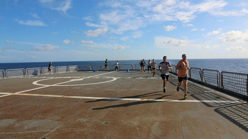 Participants in the HMAS Sirius parkrun event run laps on the ship's flight deck. Photo: Lieutenant Sarah Lucinsky 