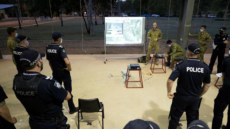 Corporal Ryan Waterham, from the 3rd Battalion, Royal Australian Regiment, demonstrates the unit's unmanned aerial system to Queensland Police officers at Lavarack Barracks, Photo: Corporal Brandon Grey