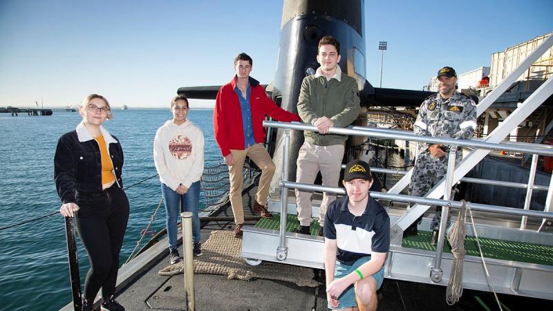 National Submarine Tour and Competition winners Shania Tutton, Emilie Cardamone, Hugh Dament, Andrew Perish and Liam Maguire stand with Petty Officer Erol Williams on HMAS Collins at Fleet Base West, WA. Photo: Chief Petty Officer Damian Pawlenko 