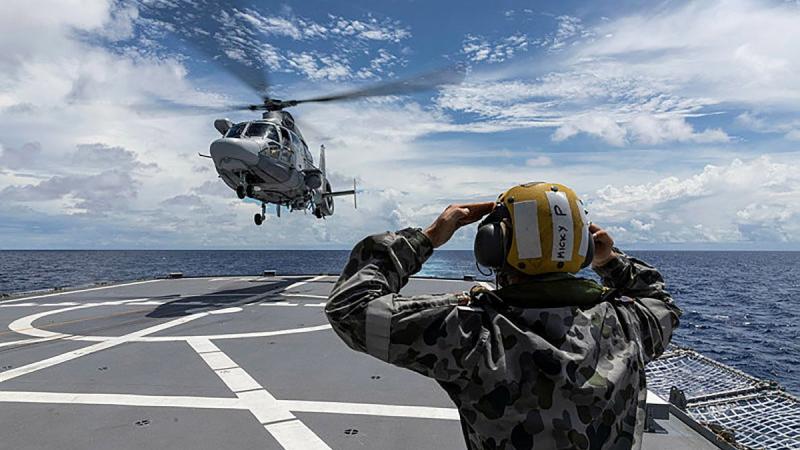 A French Navy helicopter from FS Tonnerre approaches HMAS Parramatta as the two ships sail together in the South China Sea. Photo: Leading Seaman Jarrod Mulvihill 